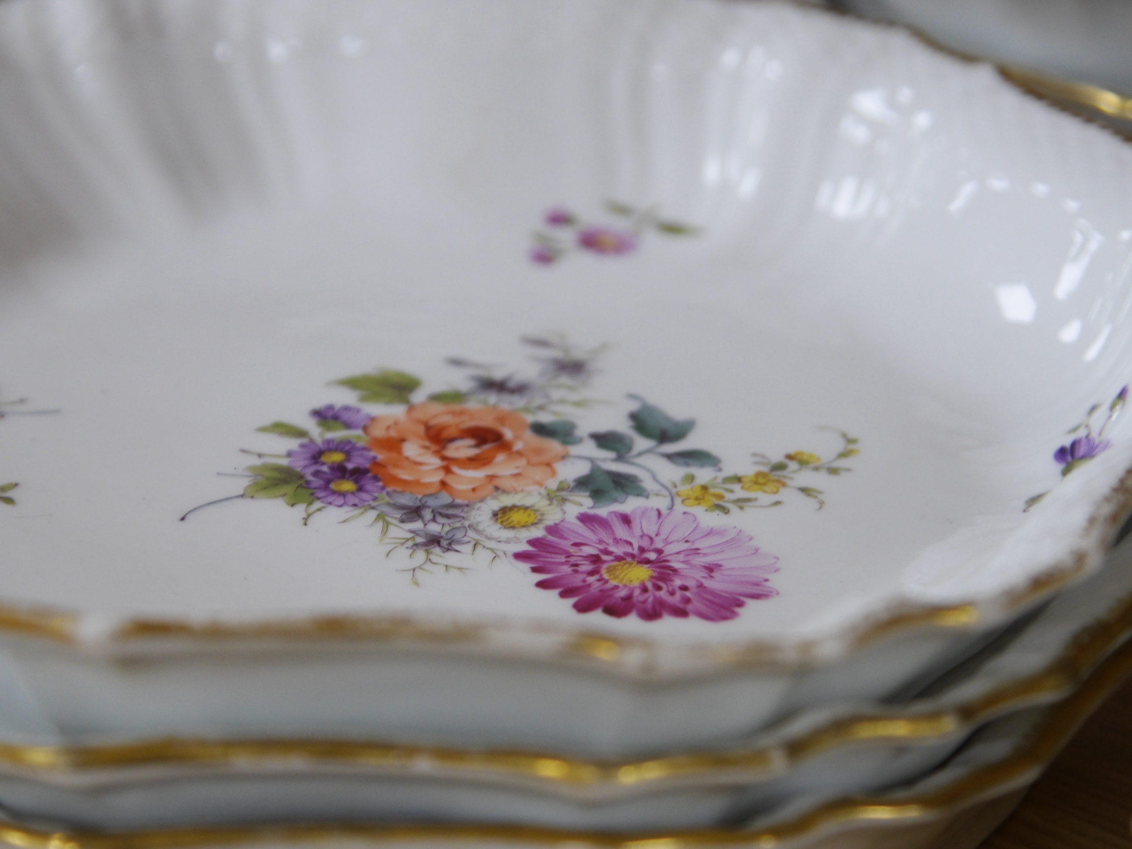 A 19th century Copenhagen floral and gilt decorated part dessert service, dishes 23cm wide. Condition - gilt edging worn